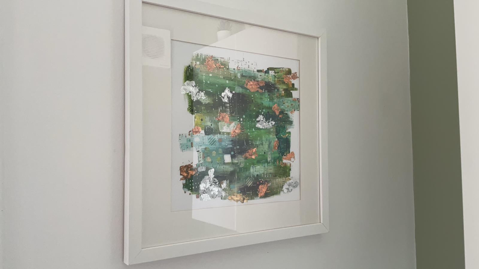 Green abstract artwork by Alice Chambers framed in a collector's home